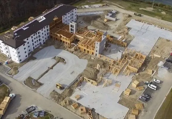 Aerial view of a multi-family building site with framing under construction