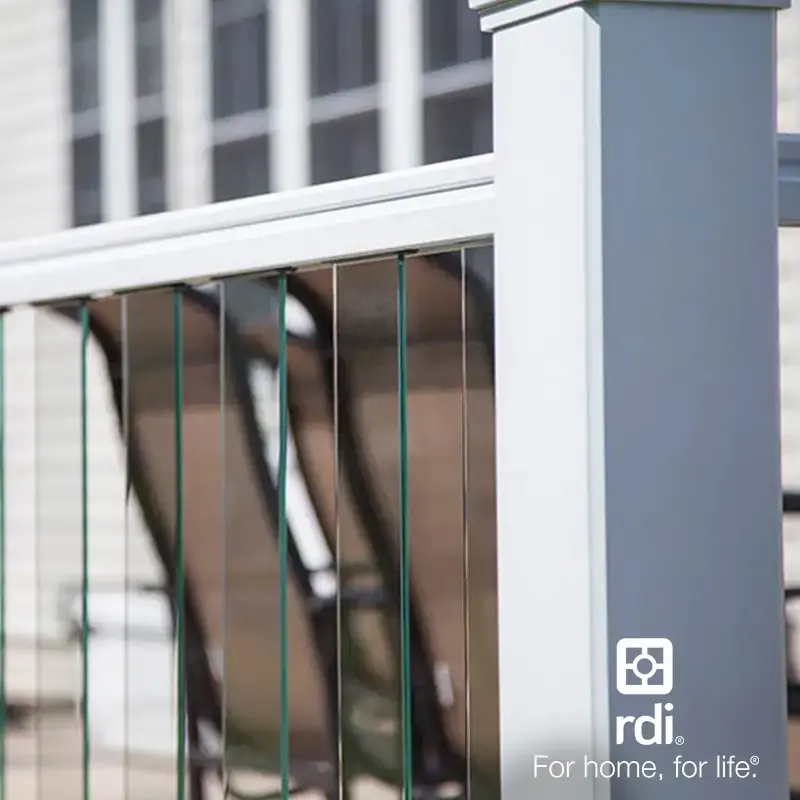 White deck railing with thin vertical cable-style balusters, with an RDI logo