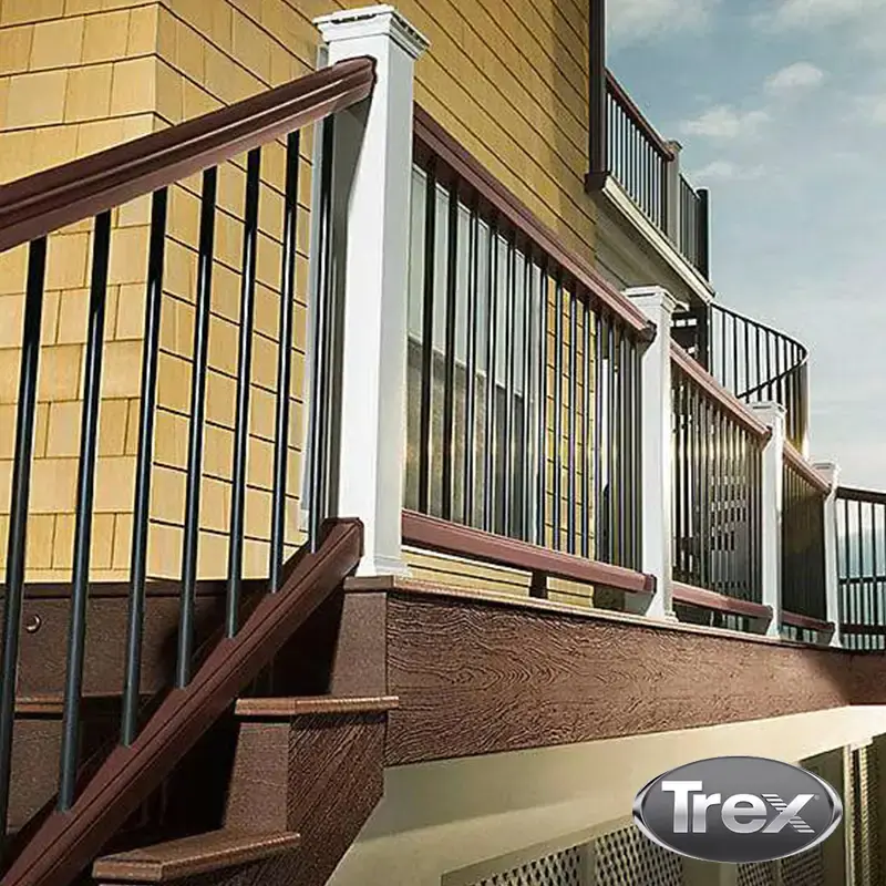 Brown composite deck with white posts and black metal balusters, with a Trex logo