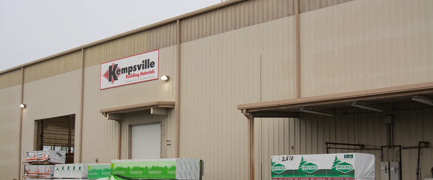 Kempsville Building Materials warehouse with wrapped lumber bundles at the loading area