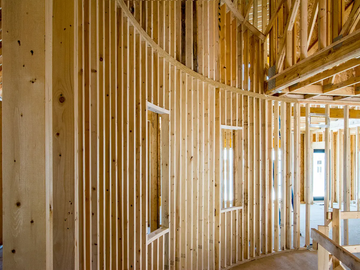 Curved interior stud wall framing inside a house under construction
