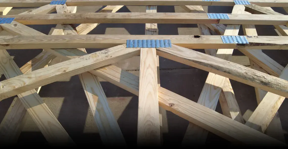 Close-up of wood trusses joined with metal connector plates