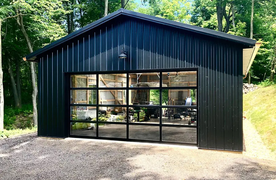 Black metal garage with a full-view glass and black-frame overhead door