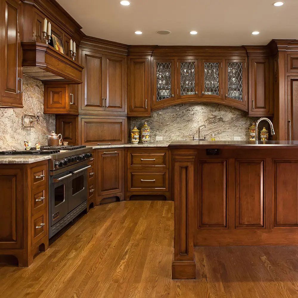 Traditional kitchen with cherry-tone cabinetry, leaded glass doors and granite backsplash